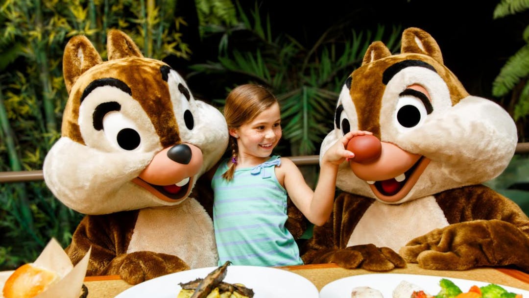 A young girl with Chip and Dale at the Garden Grill Restaurant at EPCOT